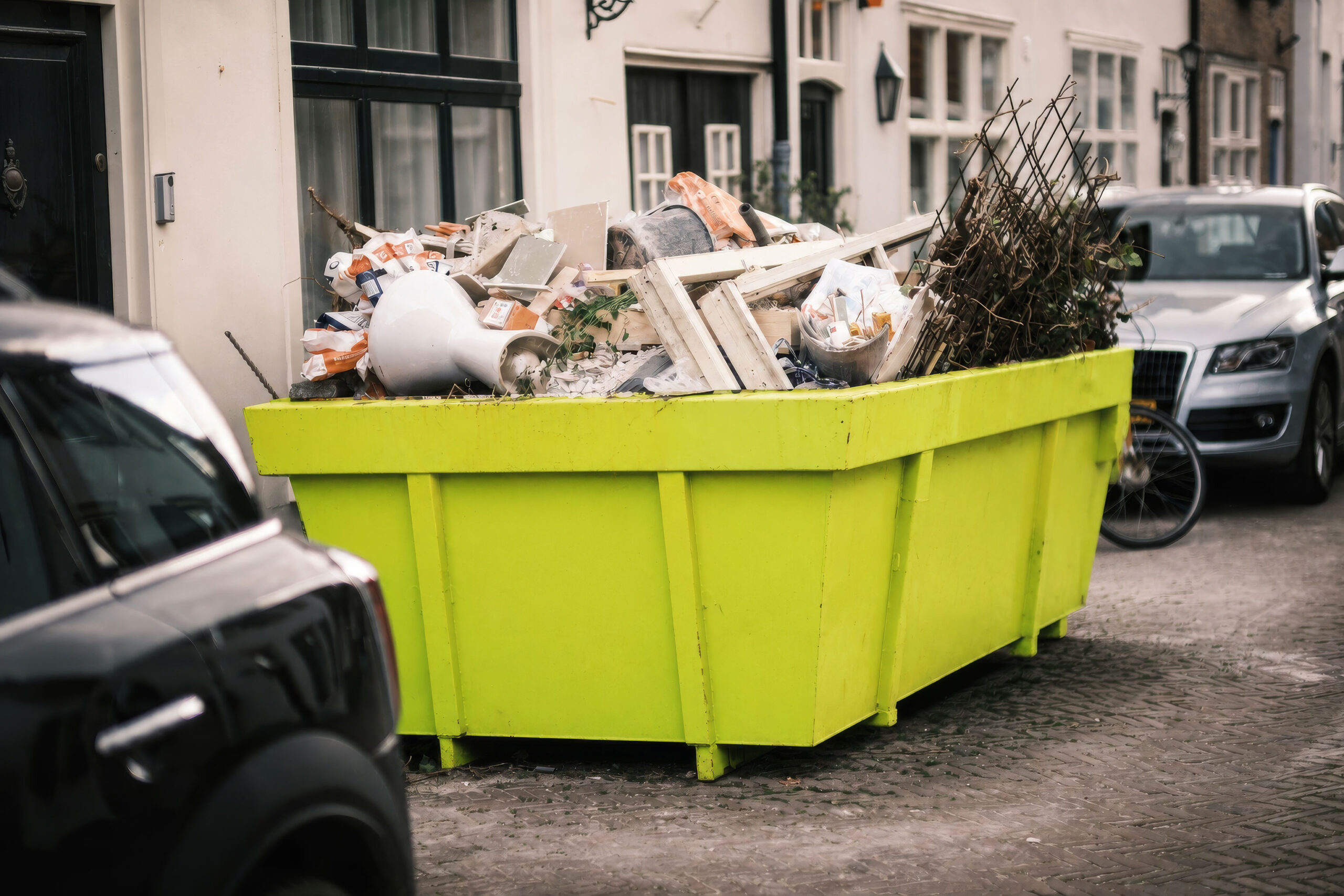 Lime skip on a street, filled with timber and construction waste