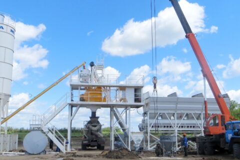 Concrete plant with a cement silo and aggregate bunkers