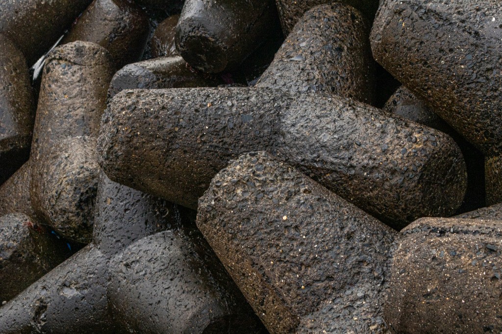 Dark interlocking concrete tetrapods in close-up