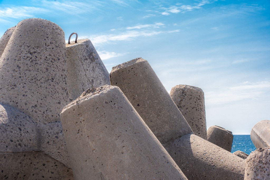 Concrete tetrapods with lifting eyes against the sky