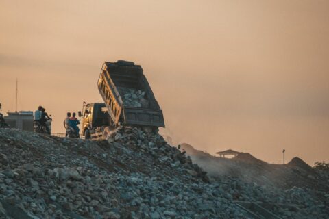 Dump truck unloading construction rubble and stone